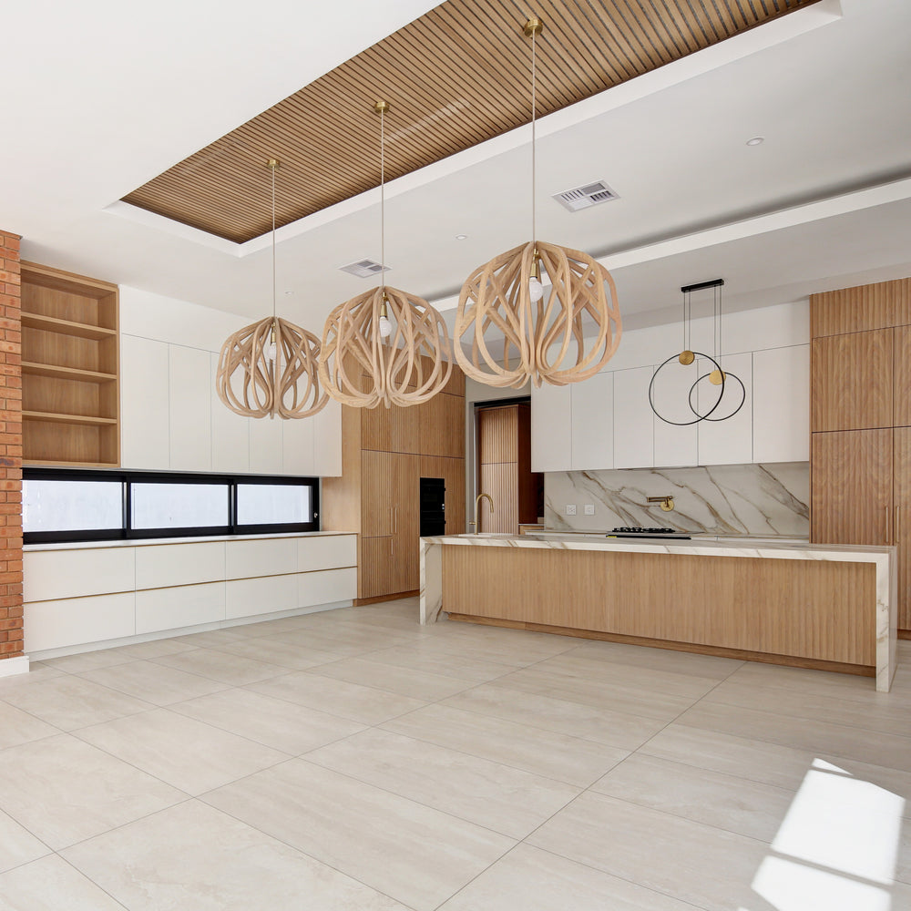 Modern kitchen with wooden pendant lights and a clean design.