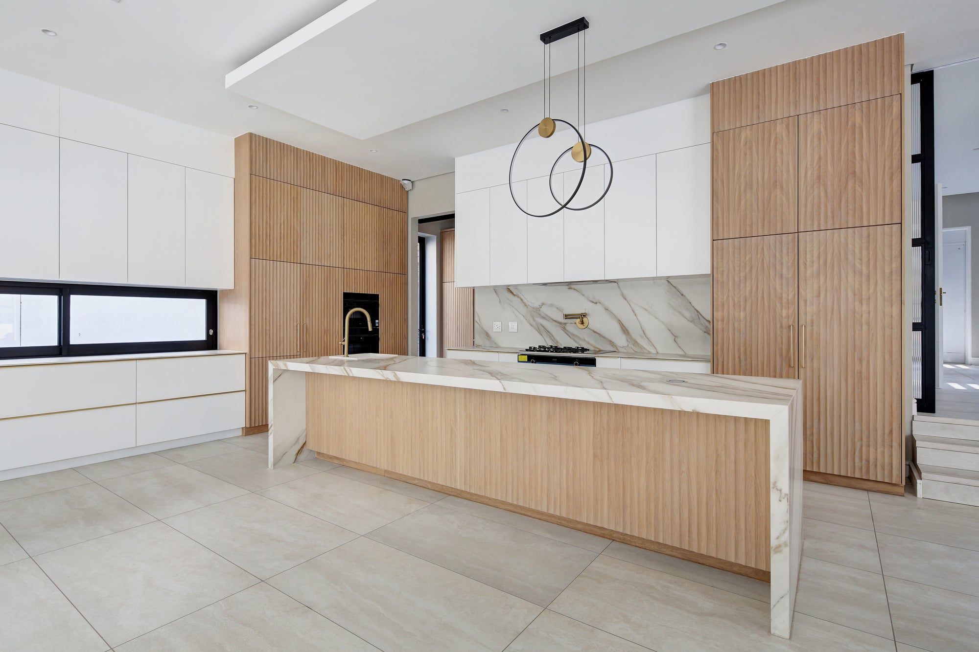 Modern kitchen with wooden cabinets and marble island