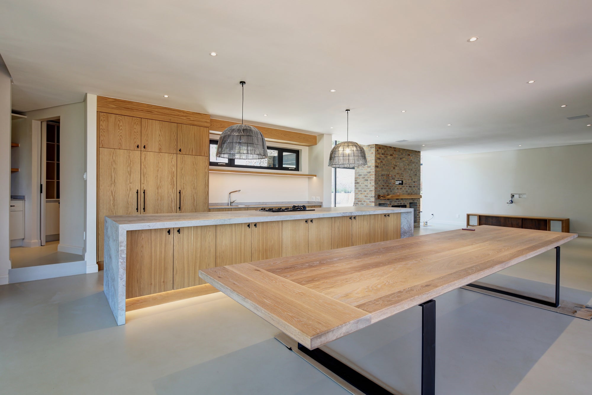 Modern kitchen with wooden island and concrete floor